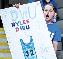Two girls holding signs with numbers on them. Description generated by AI