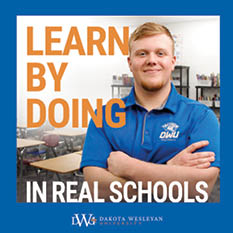 A man wearing a blue shirt with the letters DWU on it. Description generated by AI
