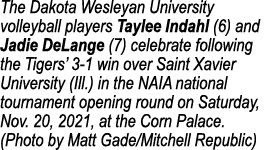 The Dakota Wesleyan University volleyball players Taylee Indahl (6) and Jadie DeLange (7) celebrate following the Tig   